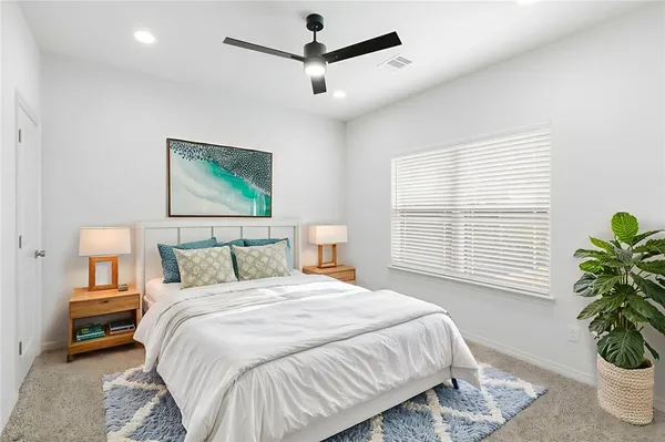 en empty room with a ceiling fan and window