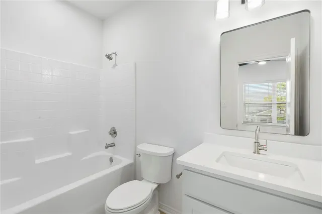 a view of a workspace with furniture and window