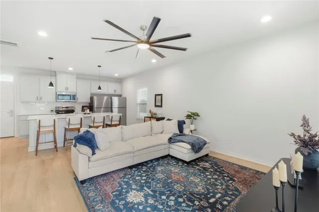 a kitchen with kitchen island granite countertop wooden cabinets and stainless steel appliances