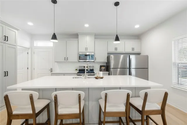 a kitchen with stainless steel appliances a stove a microwave and cabinets
