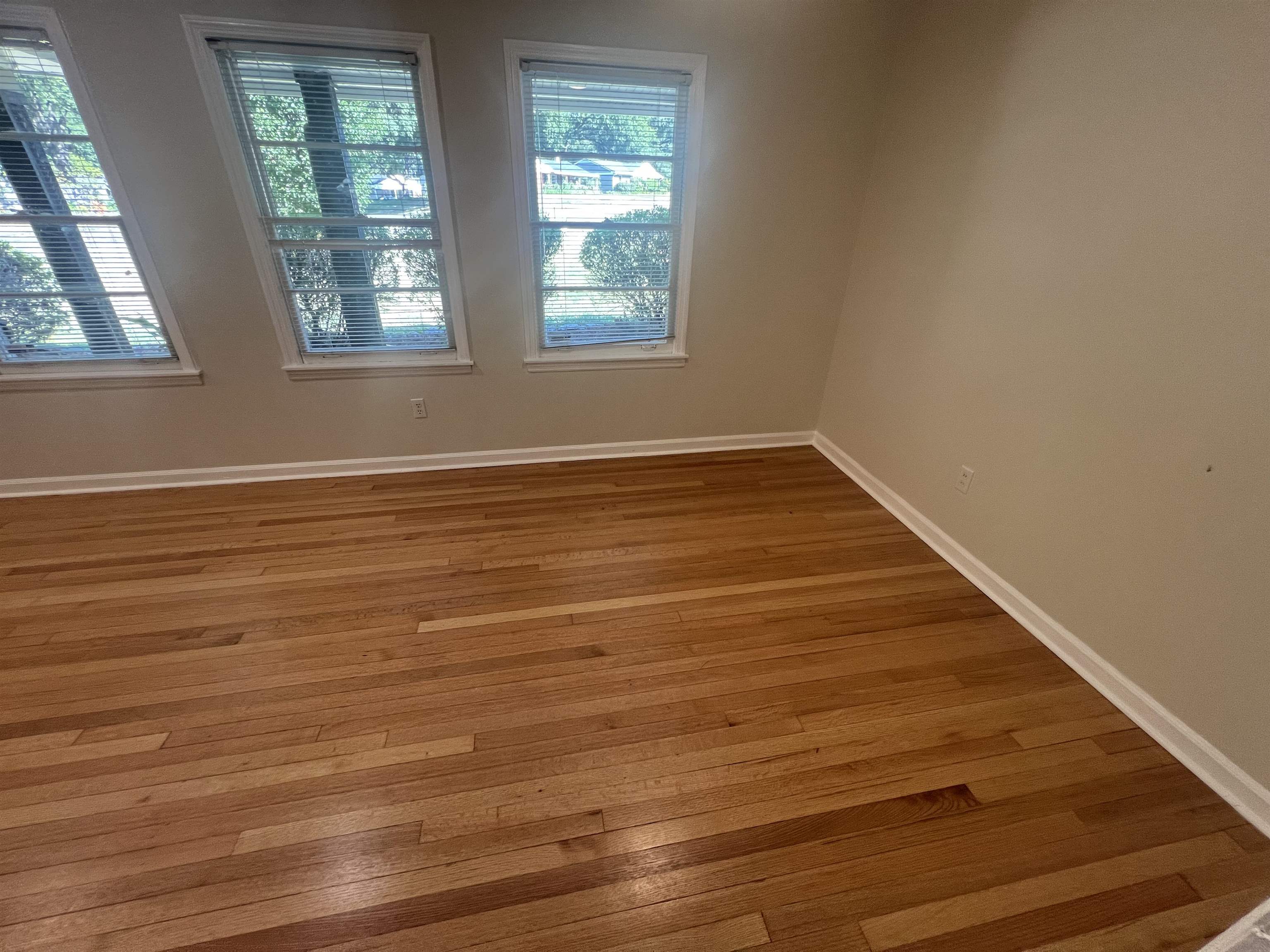 5131 Verne Road Memphis, TN 38117 - Photo 8 of 35 Empty room with a wealth of natural light and wood-type flooring