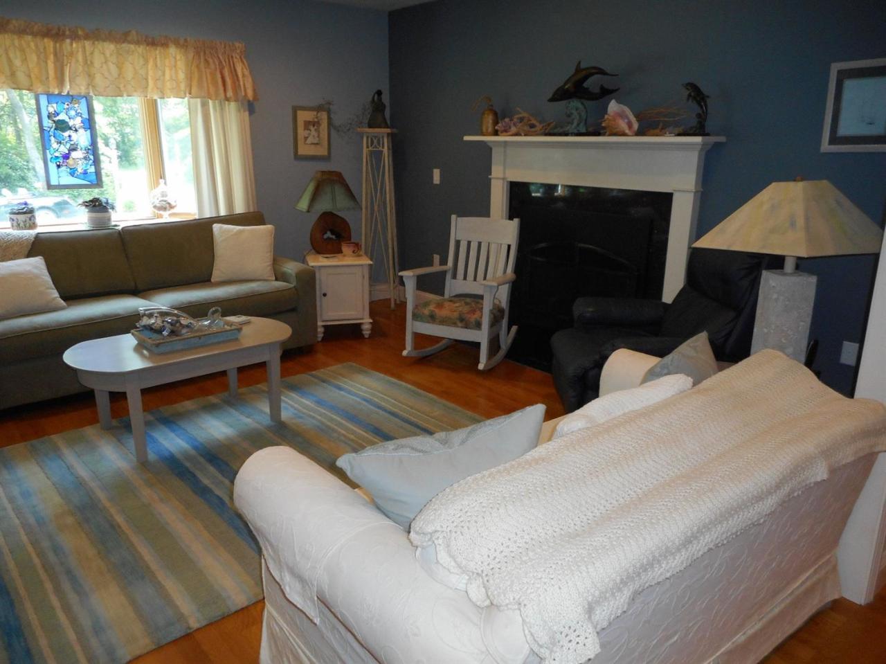 83 Norris Road Sagamore Beach, MA 02562 - Photo 4 of 16 a living room with furniture and a fireplace