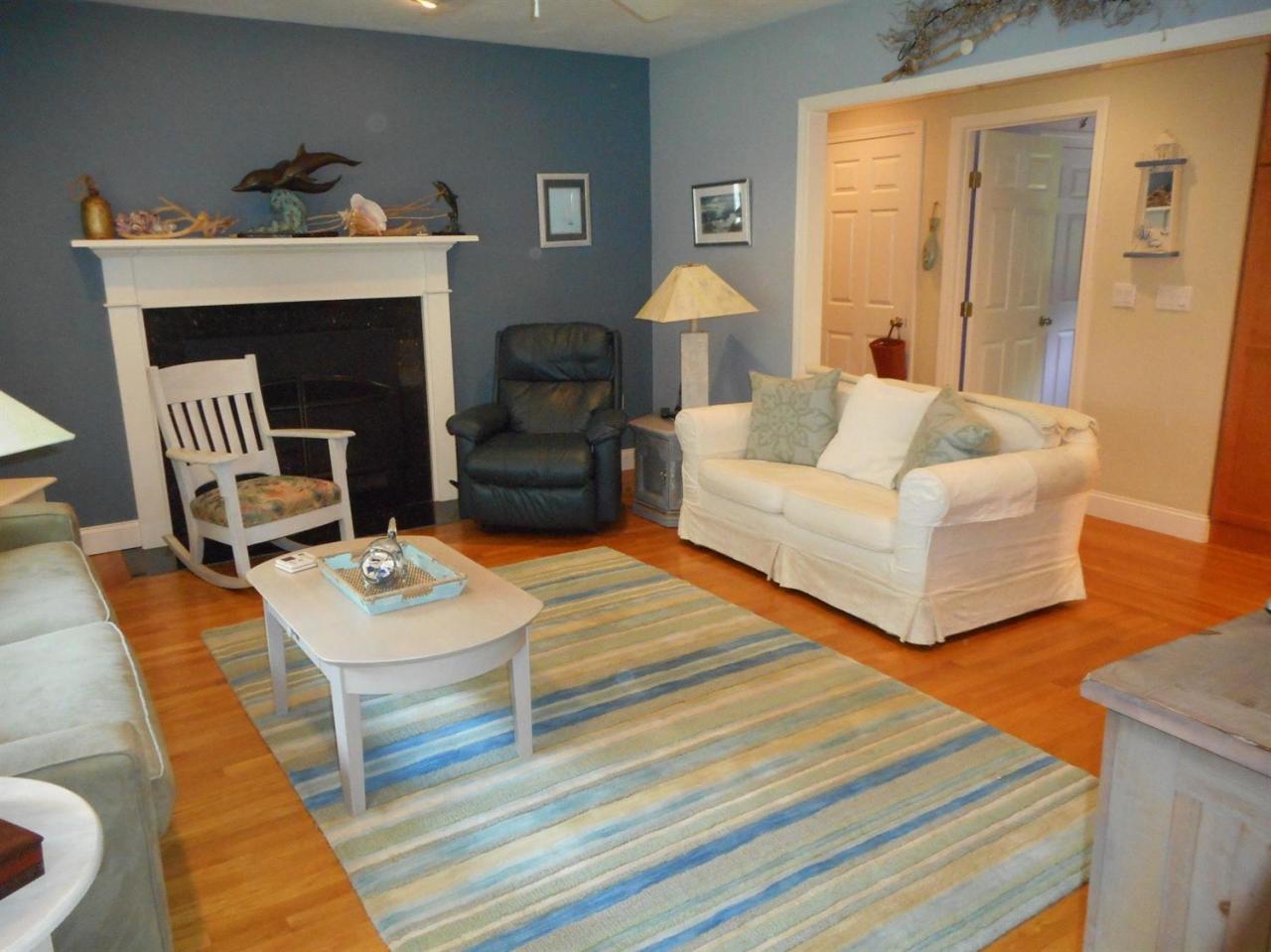 83 Norris Road Sagamore Beach, MA 02562 - Photo 5 of 16 a living room with furniture and a fireplace