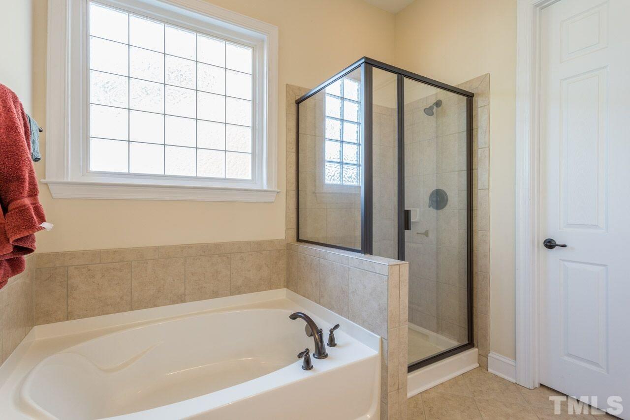 1217 Chapanoke Road Raleigh, NC 27603 - Photo 12 of 25 a white bath tub sitting next to a window