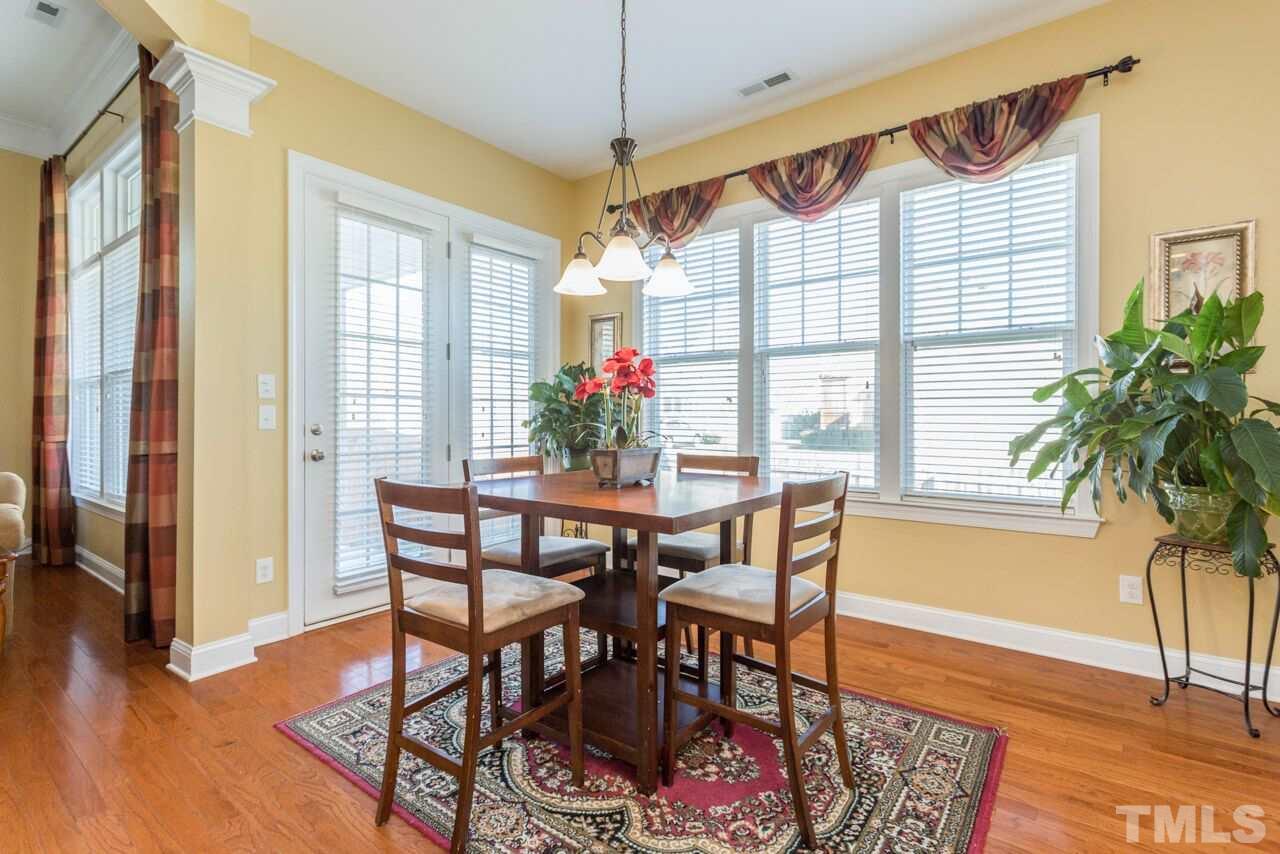 1217 Chapanoke Road Raleigh, NC 27603 - Photo 13 of 25 a view of a dining room with furniture window and wooden floor