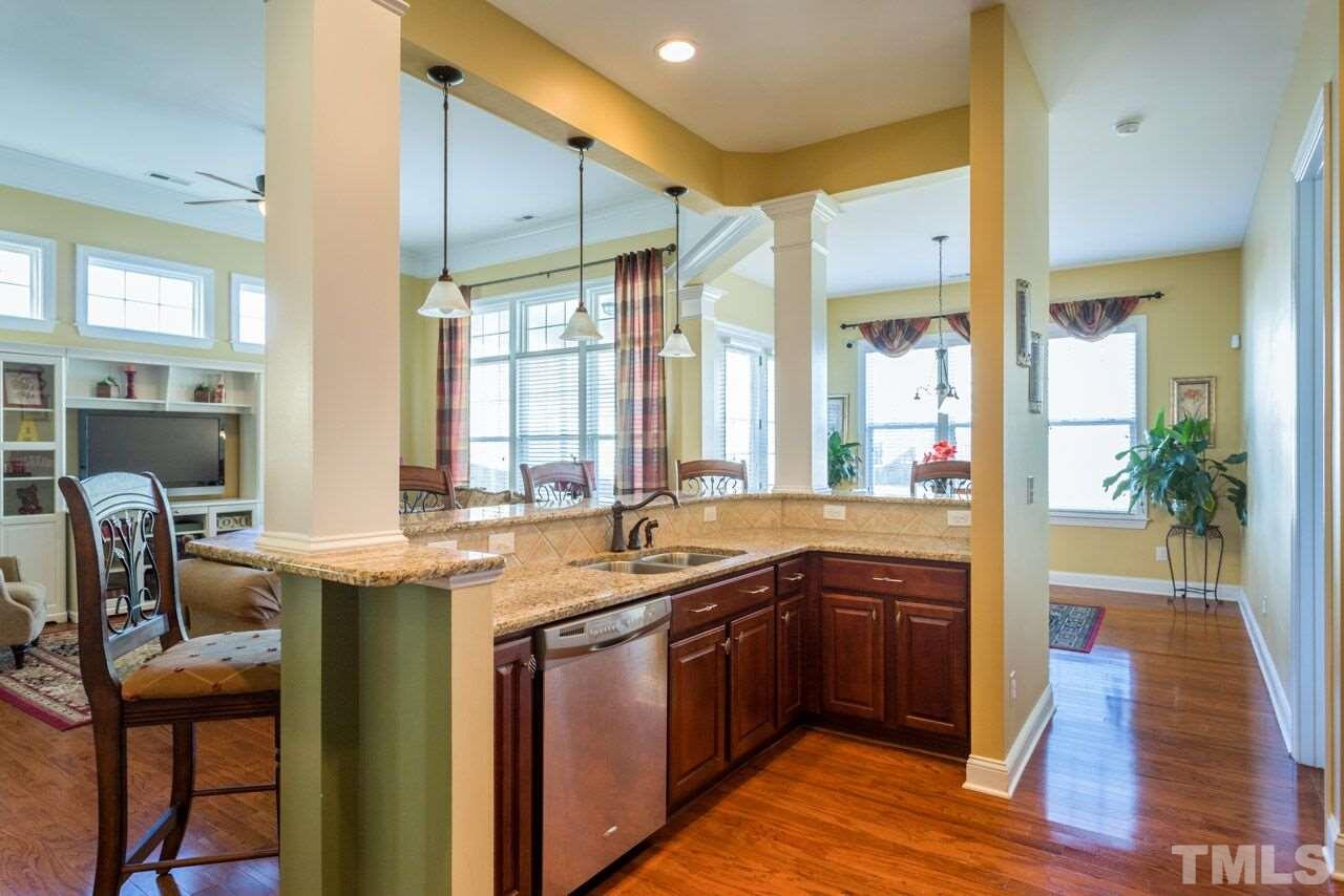 1217 Chapanoke Road Raleigh, NC 27603 - Photo 18 of 25 a kitchen with a sink and wooden cabinets
