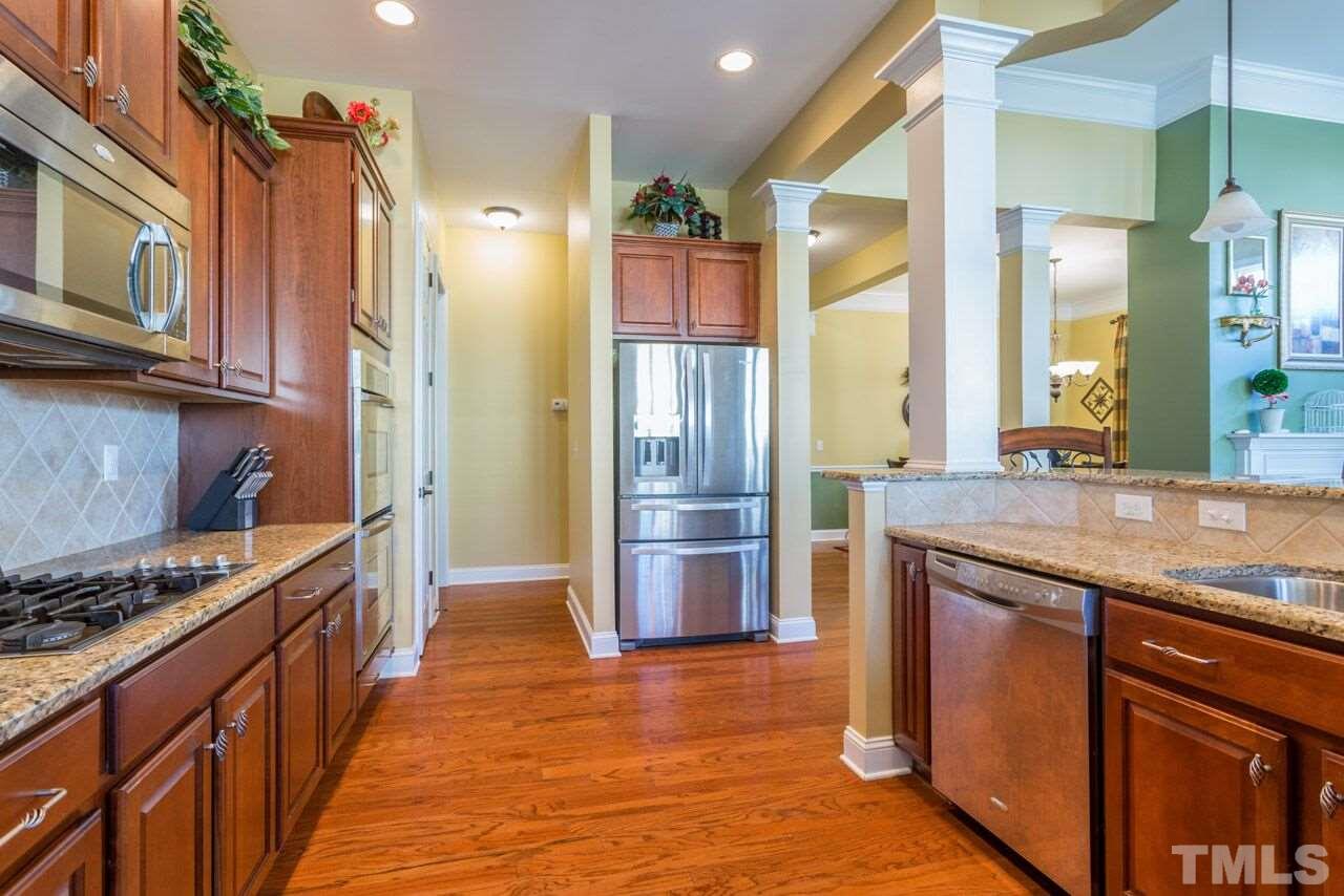 1217 Chapanoke Road Raleigh, NC 27603 - Photo 19 of 25 a kitchen with stainless steel appliances granite countertop a refrigerator a stove and a sink