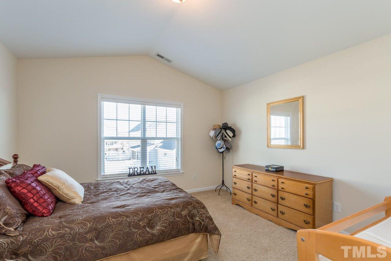 1217 Chapanoke Road Raleigh, NC 27603 - Photo 22 of 25 a bedroom with a bed and a window