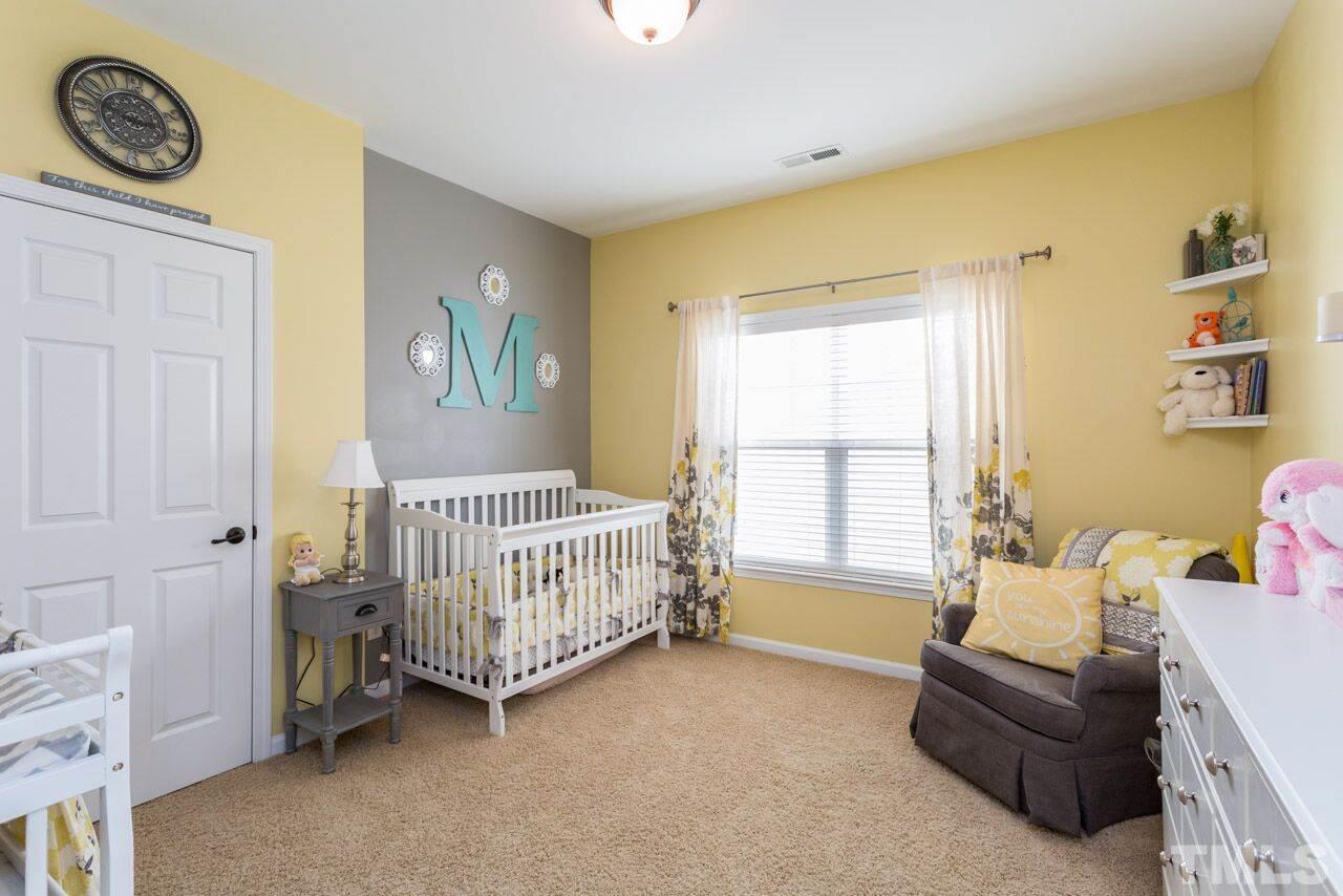 1217 Chapanoke Road Raleigh, NC 27603 - Photo 23 of 25 a bedroom with a bed and a window