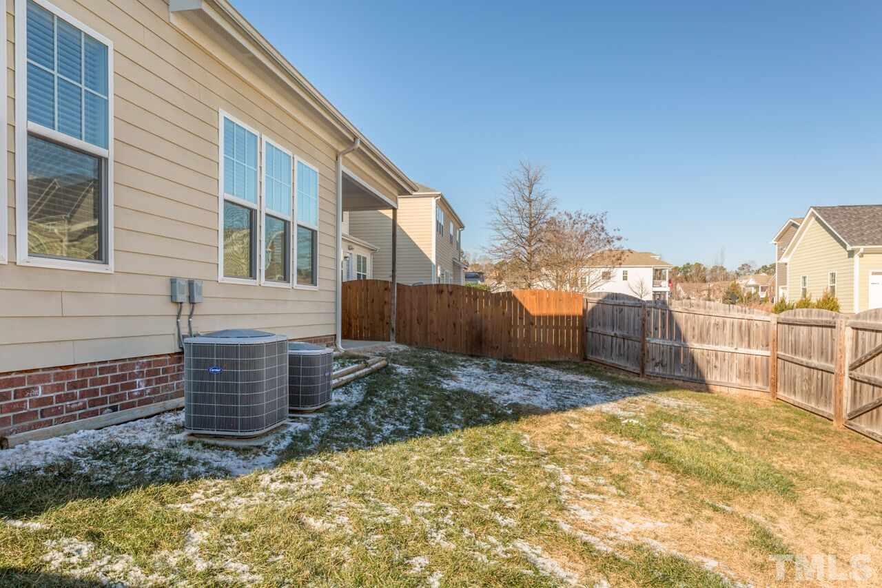 1217 Chapanoke Road Raleigh, NC 27603 - Photo 4 of 25 a view of a backyard with brick wall and plants