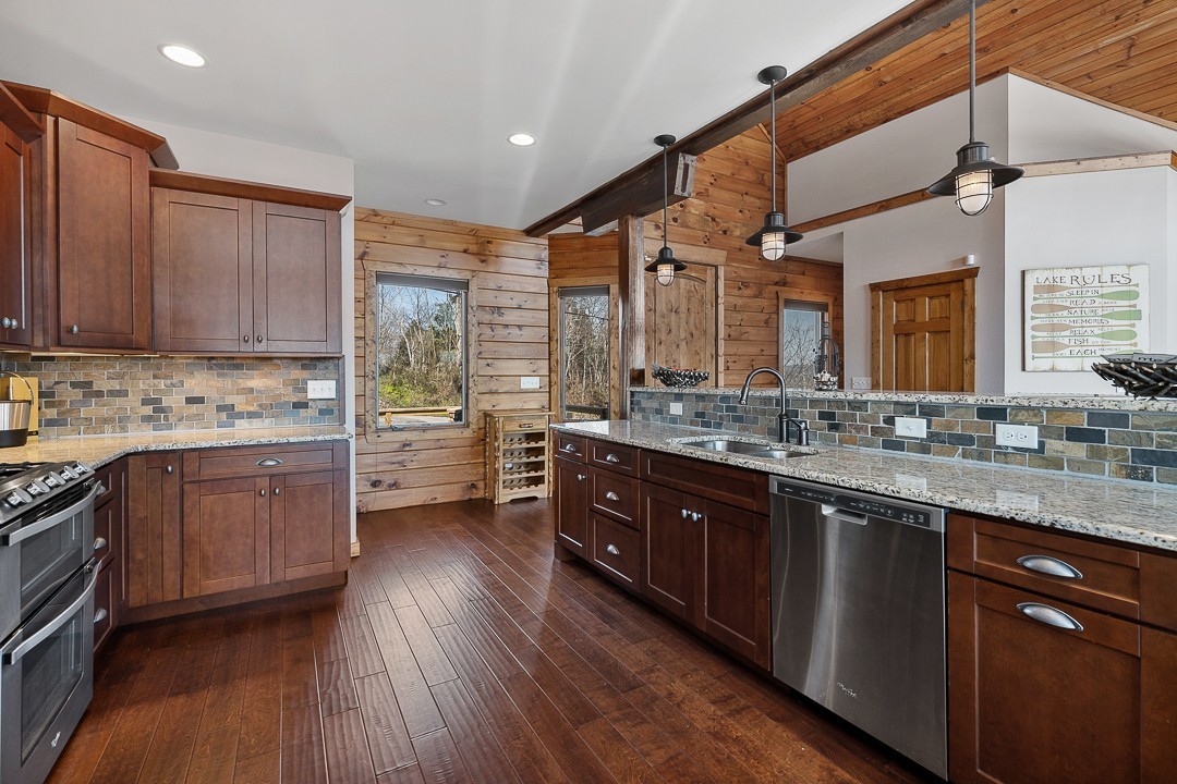 5320 Coconut Ridge Road Smithville, TN 37166 - Photo 16 of 47 a kitchen with stainless steel appliances sink cabinets and wooden floor