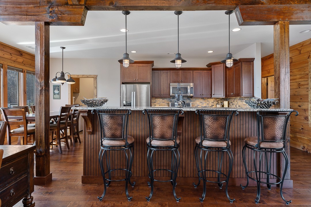 5320 Coconut Ridge Road Smithville, TN 37166 - Photo 20 of 47 a kitchen with stainless steel appliances granite countertop a stove a sink and a refrigerator