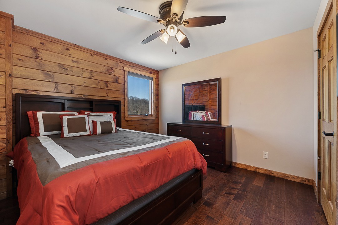 5320 Coconut Ridge Road Smithville, TN 37166 - Photo 36 of 47 a bedroom with a bed and a chandelier