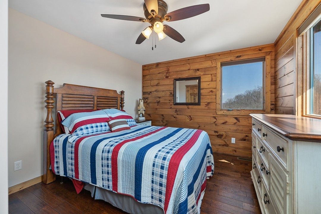 5320 Coconut Ridge Road Smithville, TN 37166 - Photo 37 of 47 a bedroom with a bed and a chandelier