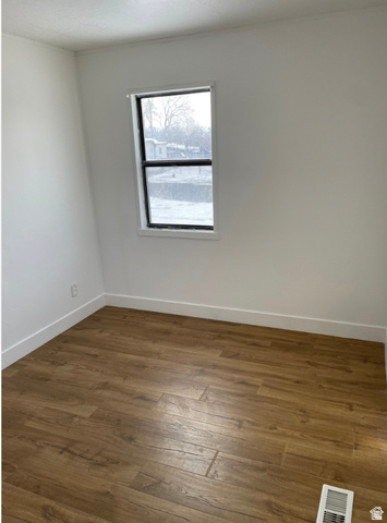 230 North 2nd Street Tooele, UT 84074 - Photo 15 of 18 Neutral-toned walls complement wood-finish flooring