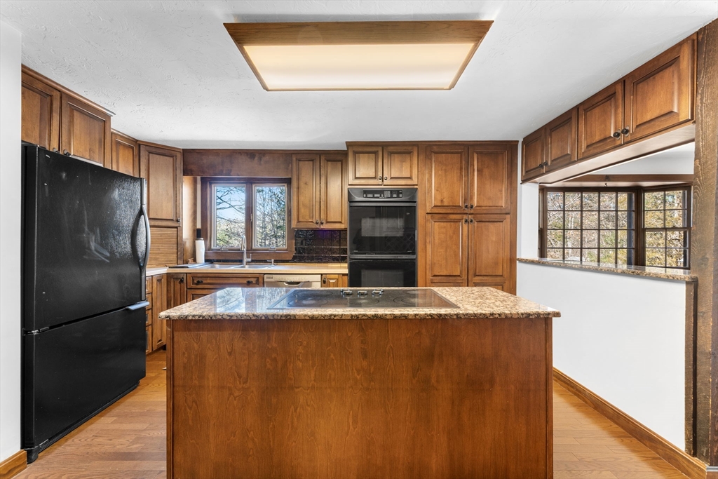210 King Phillips Pathe Marshfield, MA 02050 - Photo 14 of 42 a view of a kitchen with a sink and a refrigerator