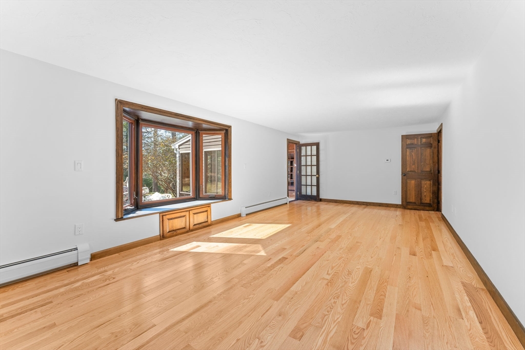 210 King Phillips Pathe Marshfield, MA 02050 - Photo 15 of 42 a view of an empty room with wooden floor and a window