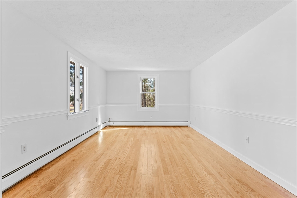 210 King Phillips Pathe Marshfield, MA 02050 - Photo 4 of 42 a view of an empty room with window and wooden floor