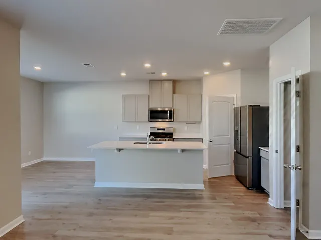 a view of kitchen with refrigerator microwave and stove