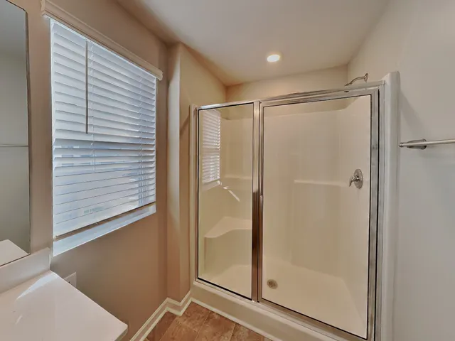 a bathroom with a glass shower door