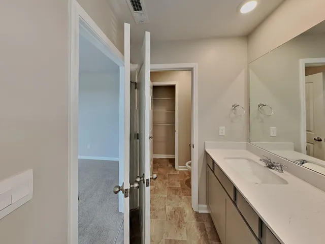 a bathroom with a double vanity sink a mirror and a shower