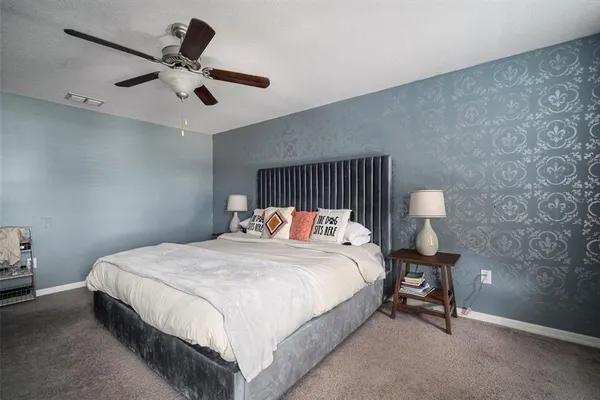 a bedroom with a bed and a lamp