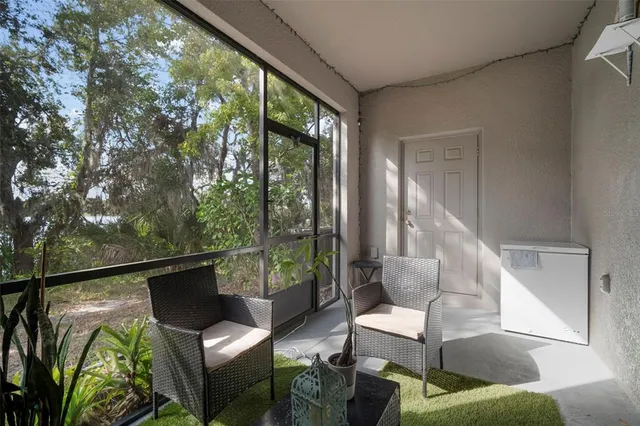a balcony with furniture and a potted plant