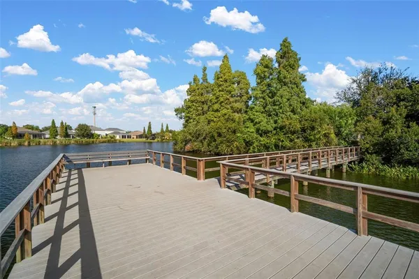 a view of balcony with wooden floor and fence