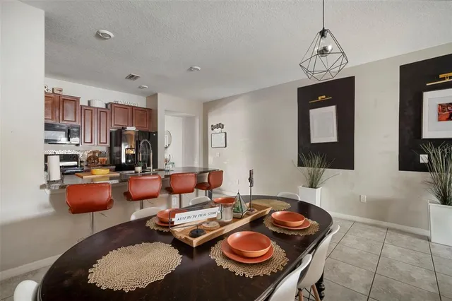 a living room with furniture a rug and a view of kitchen