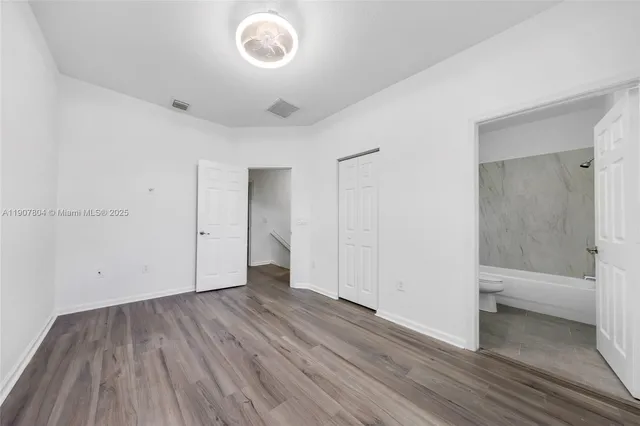 a view of a room with wooden floor