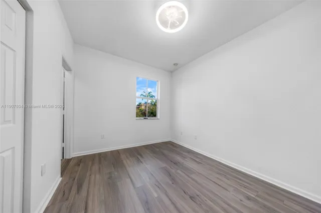 a view of room with window and hardwood floor