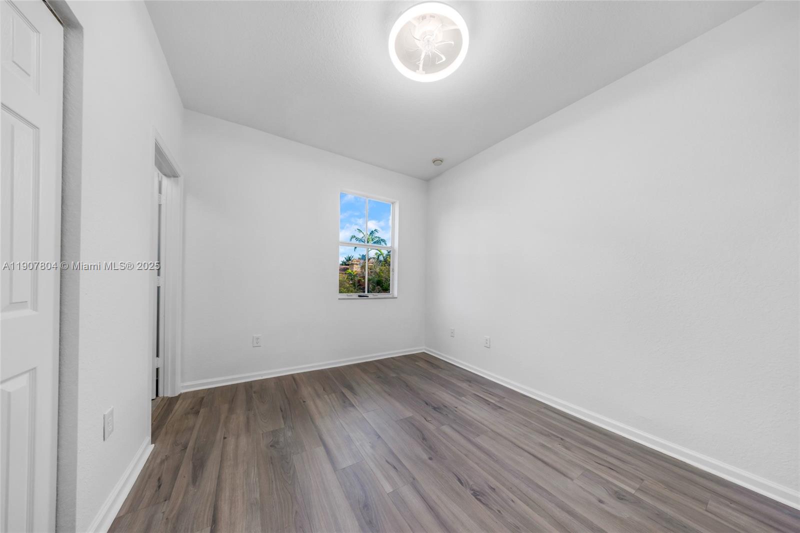 12040 Southwest 28th Street, Unit 4064 Miramar, FL 33025 - Photo 13 of 19 a view of room with window and hardwood floor