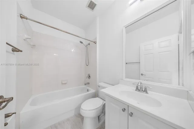 a view of a house with a small yard and wooden fence