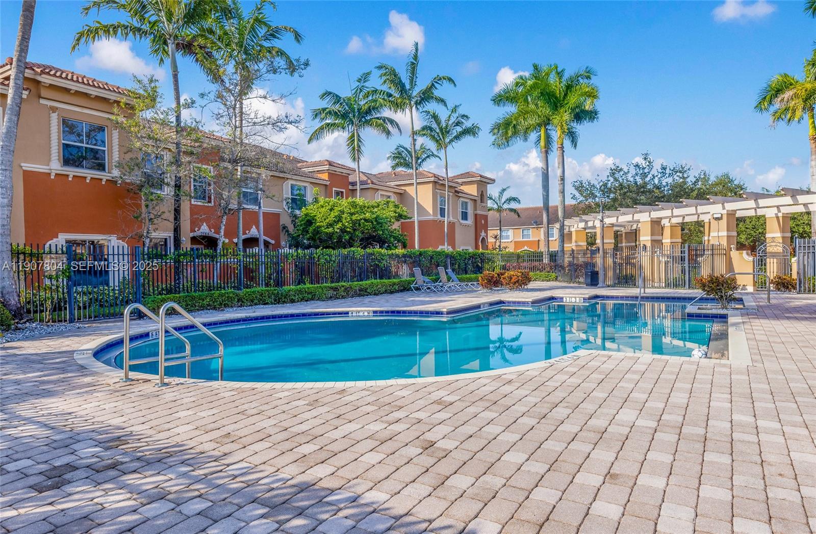 12040 Southwest 28th Street, Unit 4064 Miramar, FL 33025 - Photo 19 of 19 a view of a swimming pool with a garden and patio