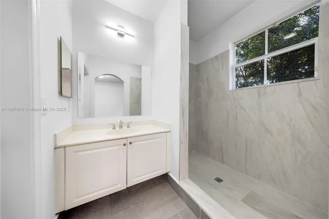 a bathroom with a double vanity sink and a mirror