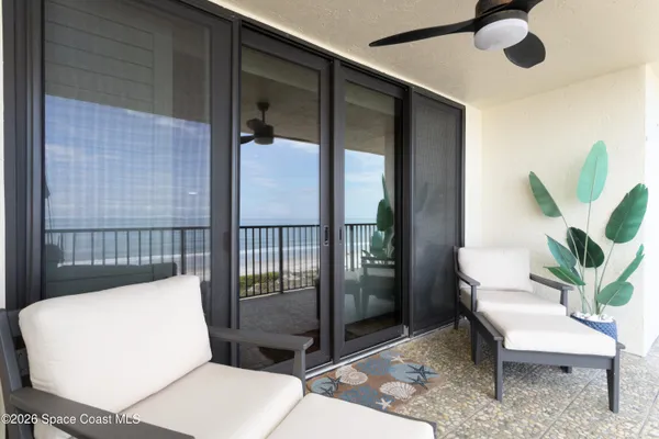 a view of a hallway with wooden floor windows and a livingroom