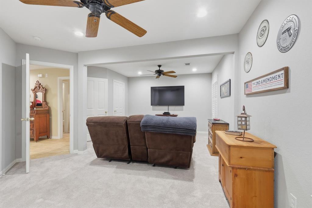 2012 Hayden Lane Corinth, TX 76210 - Photo 31 of 40 a living room with furniture and a flat screen tv