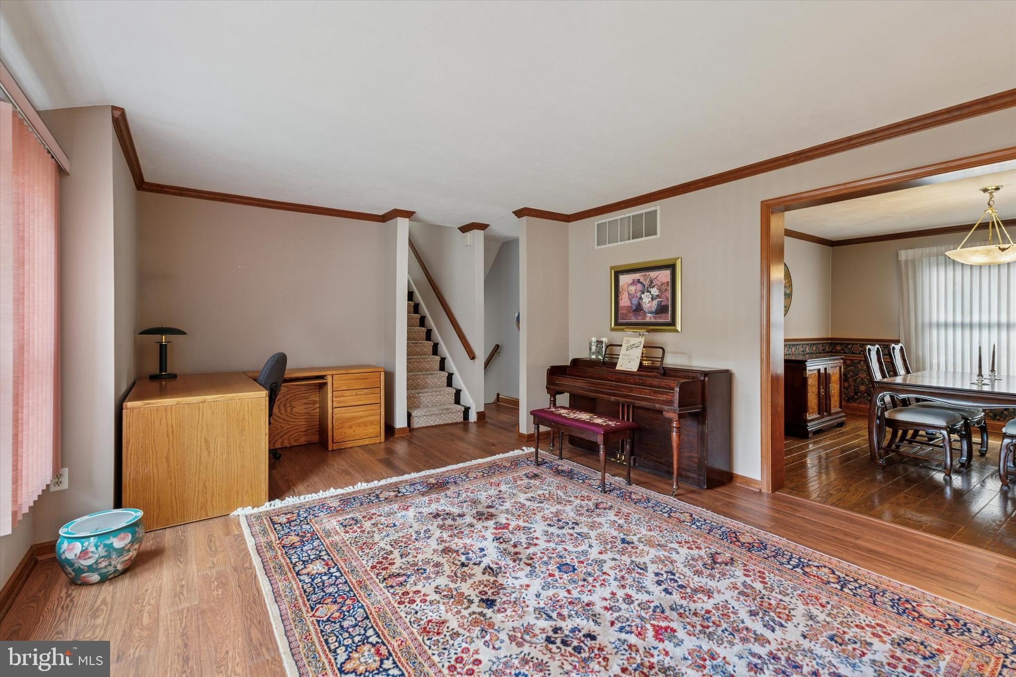 2463 Pine Cone Road Warrington, PA 18976 - Photo 14 of 44 a living room with furniture a dining table and wooden floor