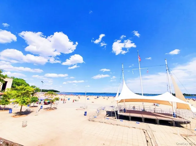 a bathroom with a sink mirror and chandelier