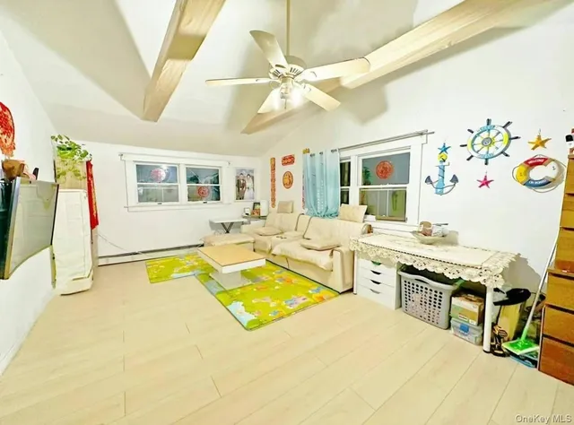 a spacious bedroom with a bed a dresser and a large mirror