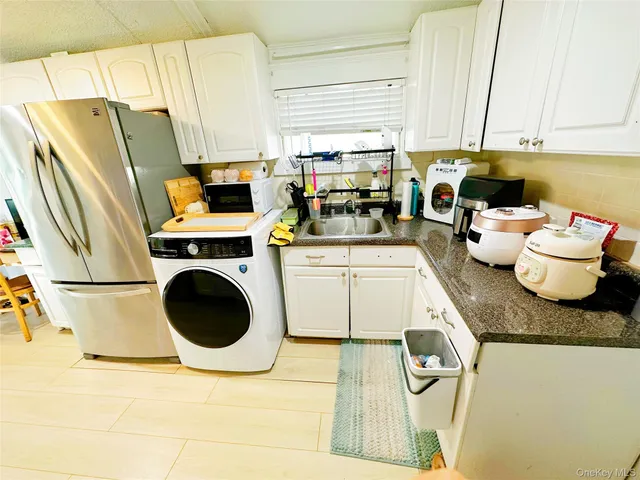 a kitchen with a refrigerator and a stove top oven