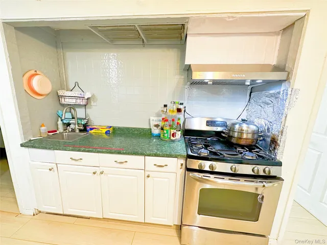 a kitchen with stainless steel appliances granite countertop a sink and a stove