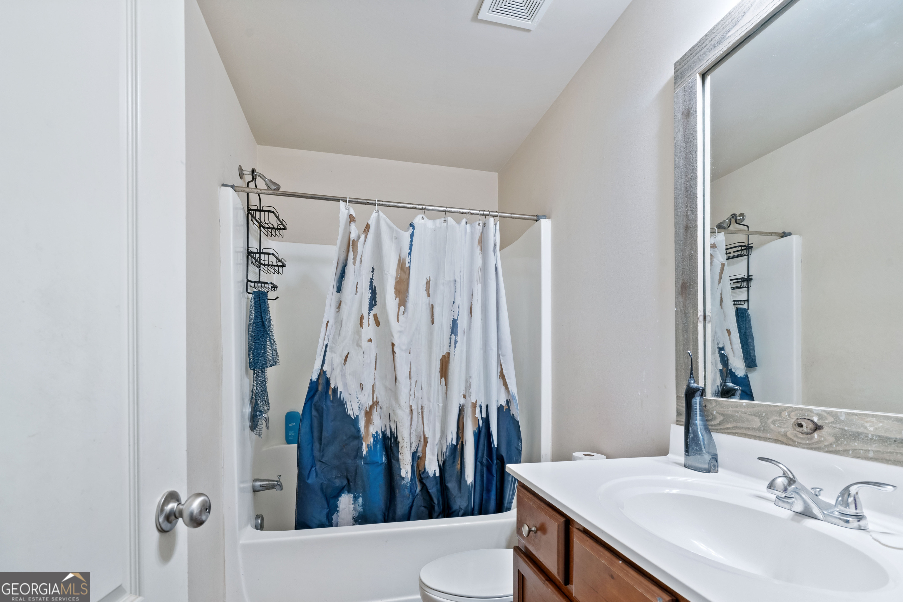 3487 Desoto Road Snellville, GA 30078 - Photo 12 of 13 a bathroom with a sink a toilet and a mirror