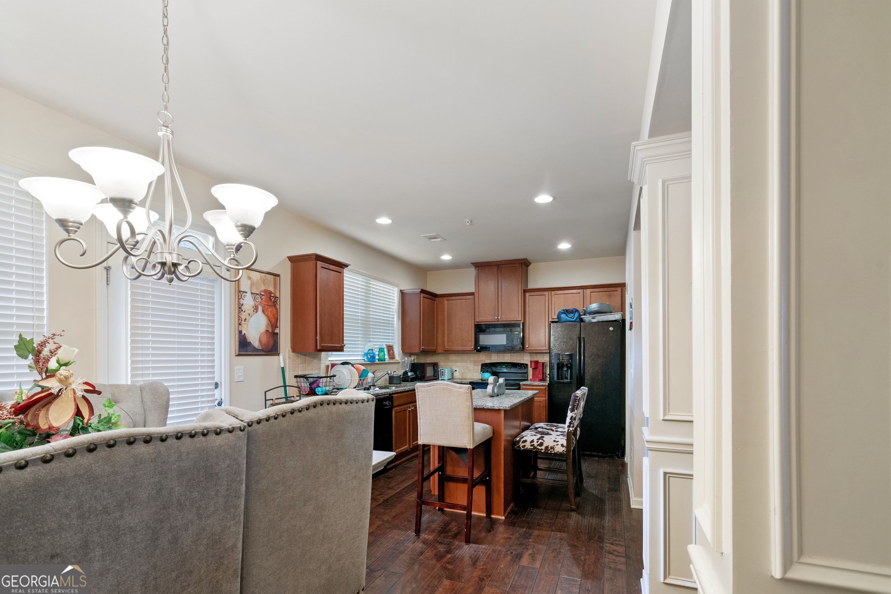 3487 Desoto Road Snellville, GA 30078 - Photo 5 of 13 a view of a dining room and livingroom with furniture wooden floor a chandelier