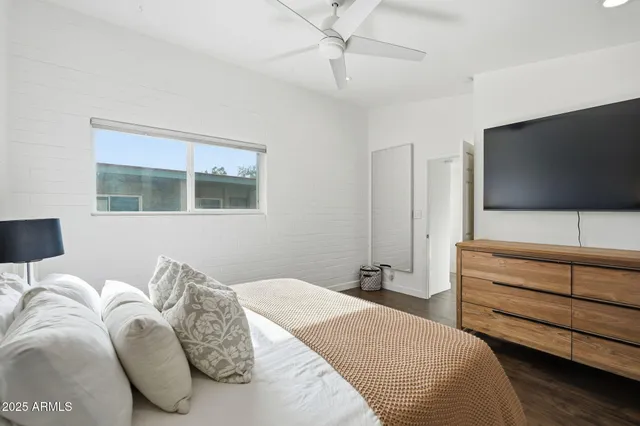 a bedroom with a bed and a flat screen tv