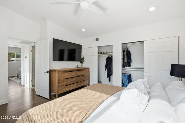 a bedroom with a bed and a flat screen tv