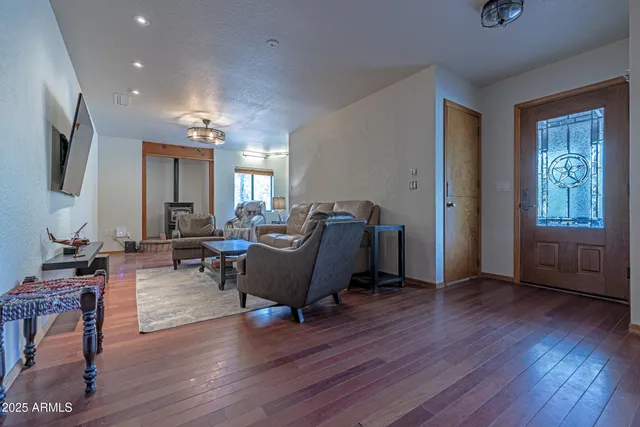 a living room with a fireplace and a mirror