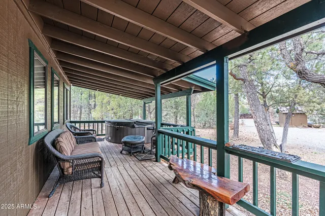 a front view of a house with a yard and large tree