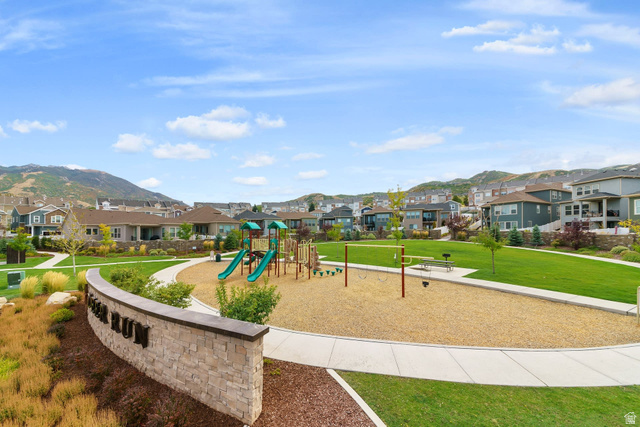 987 East Deer Arch Lane Draper, UT 84020 - Photo 45 of 46 Community park with play structures, open green space, paved walkways, and mountain backdrop
