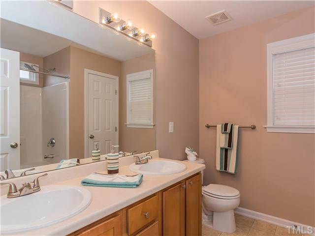 108 Hardaway Point Clayton, NC 27527 - Photo 13 of 21 a bathroom with a sink and a mirror
